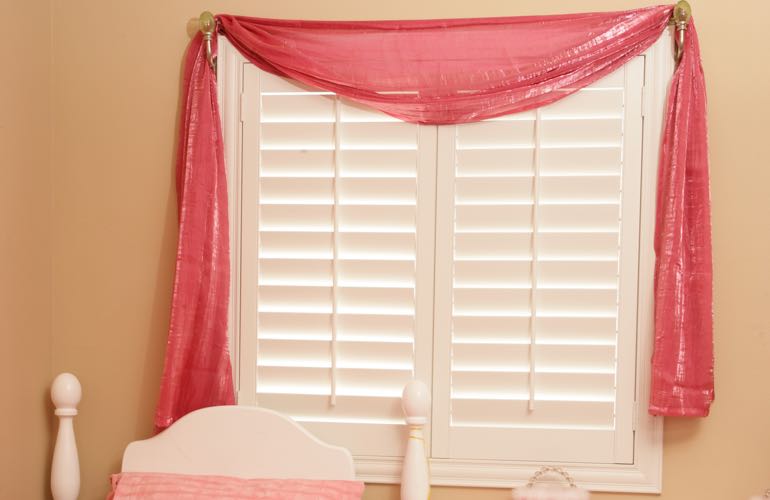 Kid's bedroom with white shutters.